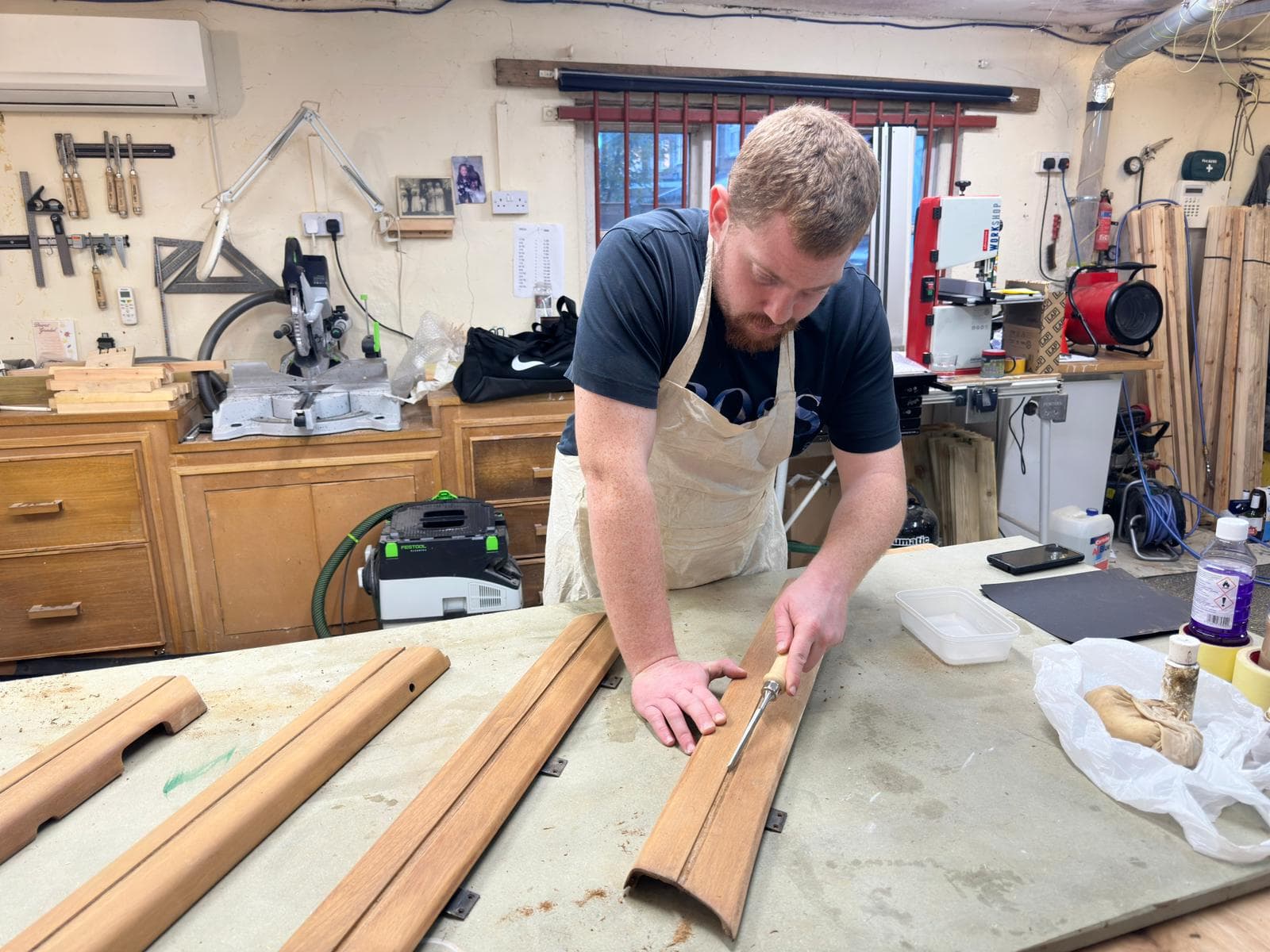 Master craftsman working on vehicle components in our heritage workshop